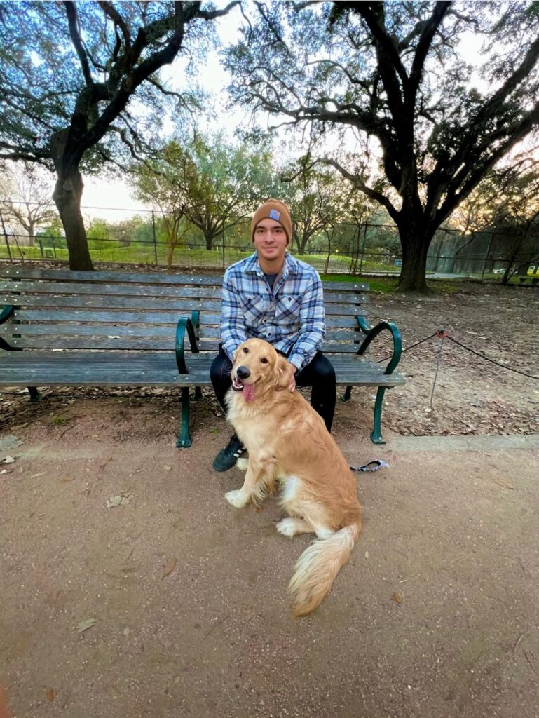 golden retriever sitting with owner